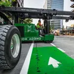 欧米茄澳门威斯人平台首页机械公司的搬运工在西雅图市中心驾驶绿色电梯的缩略图.